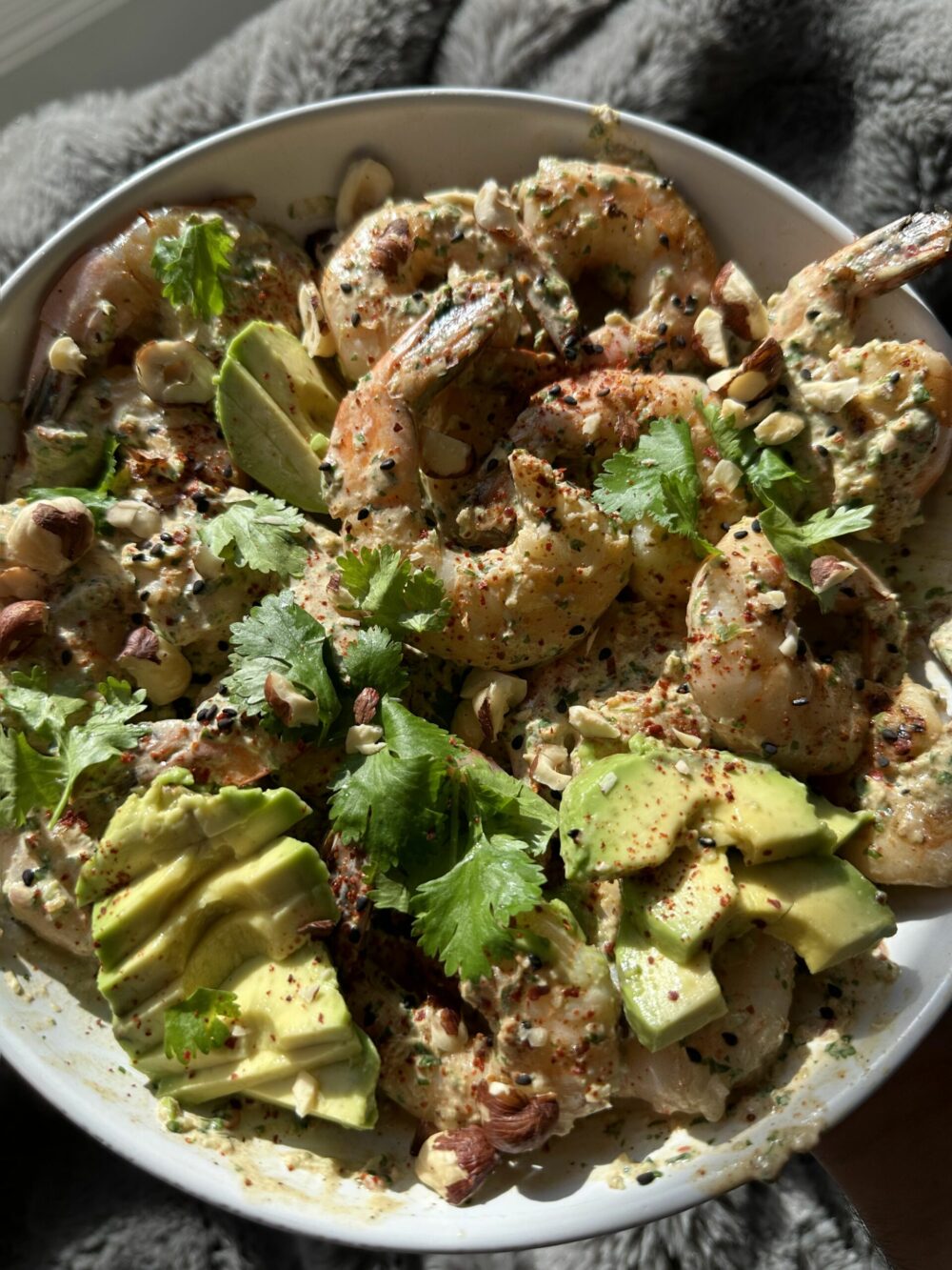 A bowl of low-carb shrimp with avocados and cilantro.